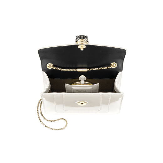 “Serpenti Forever” crossbody bag in agate-white calfskin with a polished, pearly finish and black grosgrain inner lining. Alluring snakehead closure in light gold-plated brass enriched with black and pearly, agate-white enamel and black onyx eyes 422-VCL image 4