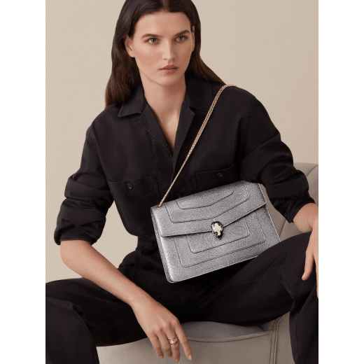 “Serpenti Forever” shoulder bag in Charcoal Diamond grey metallic karung skin with Charcoal Diamond grey nappa leather internal lining. Tempting snakehead closure light gold plated brass enriched with black and glitter Hawk's Eye grey enamel and black onyx eyes. 1089-MK image 2
