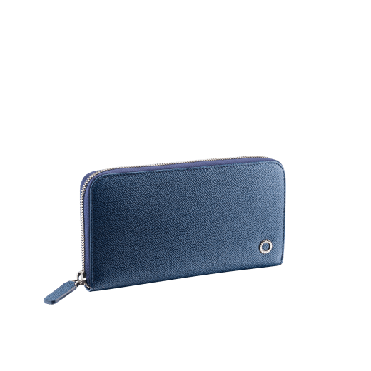 Zipped wallet in black grain calf leather with royal blue nappa lining. Brass palladium plated hardware featuring the Bvlgari-Bvlgari motif. Eight credit card slots, two internal compartments, one zipped coin case in the middle and two additional compartments. Zip-around closure. BBM-WLT-M-ZIPa image 1