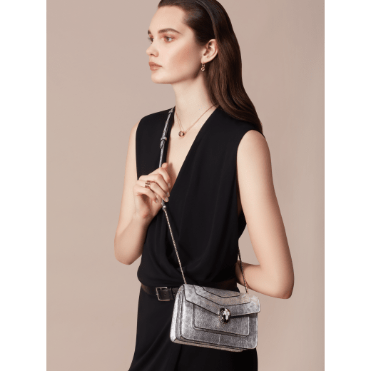 “Serpenti Forever” crossbody bag in charcoal diamond metallic karung skin. Iconic snakehead closure in light gold plated brass enriched with black and glitter hawk's eye enamel and black onyx eyes. 1082-MK image 5