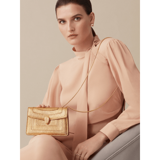 "Serpenti Forever" mini crossbody bag in "Molten" gold karung skin with black nappa leather inner lining, offering a touch of radiance for the Winter Holidays. New Serpenti head closure in gold-plated brass, complete with ruby-red enamel eyes. 986-MolK image 5