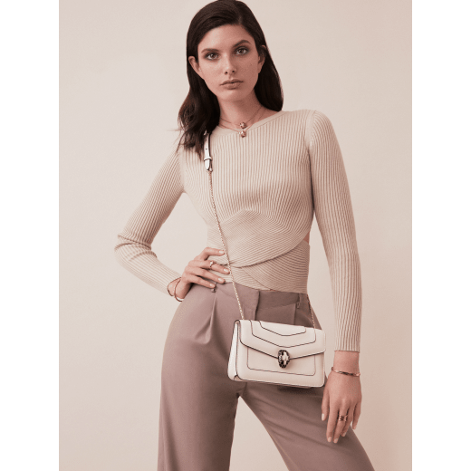 “Serpenti Forever” crossbody bag in agate-white calfskin with Heather Amethyst purple grosgrain inner lining. Iconic snakehead closure in light gold-plated brass embellished with black and agate-white enamel and green malachite eyes 625-CLa image 5