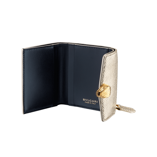 Slender, compact "Serpenti Forever" wallet in "Molten" gold karung skin and black calfskin, offering a touch of radiance for the Winter Holidays. New Serpenti head closure in gold-plated brass, complete with ruby-red enamel eyes. SEA-SLIMCOMPACT-MoltK image 2