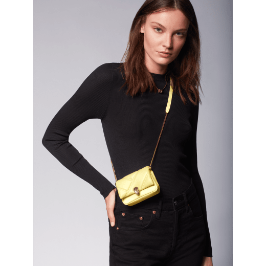 Serpenti Cabochon micro bag in ivory opal calf leather with a maxi matelassé pattern and black nappa leather lining. Captivating snakehead closure in gold-plated brass embellished with red enamel eyes. SCB-NANOCABOCHON image 5