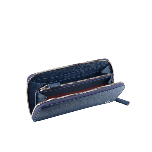 Zipped wallet in black grain calf leather with royal blue nappa lining. Brass palladium plated hardware featuring the Bvlgari-Bvlgari motif. Eight credit card slots, two internal compartments, one zipped coin case in the middle and two additional compartments. Zip-around closure. BBM-WLT-M-ZIPa image 2
