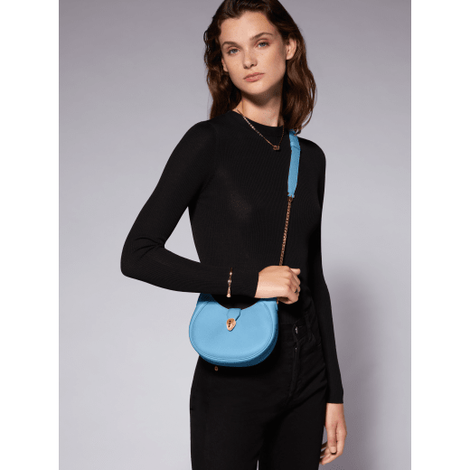 Serpenti Ellipse small crossbody bag in Urban grain and smooth flamingo quartz pink calf leather with flamingo quartz pink gros grain lining. Captivating snakehead closure in gold-plated brass embellished with black onyx scales and red enamel eyes. Online exclusive colour. 1204-Hobo image 7