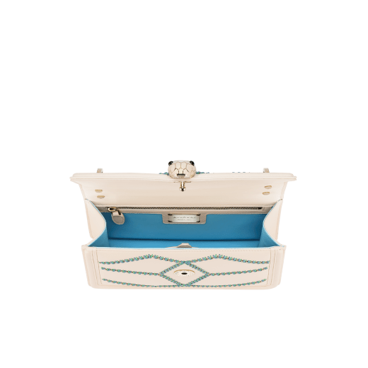Serpenti Diamond Blast small shoulder bag in ivory opal calf leather with twisted chain and leather décor, and Niagara sapphire blue nappa leather lining. Captivating snakehead closure in light gold-plated brass embellished with matt and shiny ivory opal enamel scales and black onyx eyes. 291725 image 4