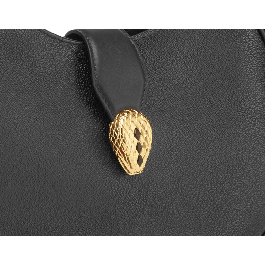 Serpenti Ellipse medium shoulder bag in Urban grain and smooth Niagara sapphire blue calf leather with cloud topaz blue gros grain lining. Captivating snakehead closure in gold-plated brass embellished with black onyx scales and red enamel eyes. 1190-UCL image 6