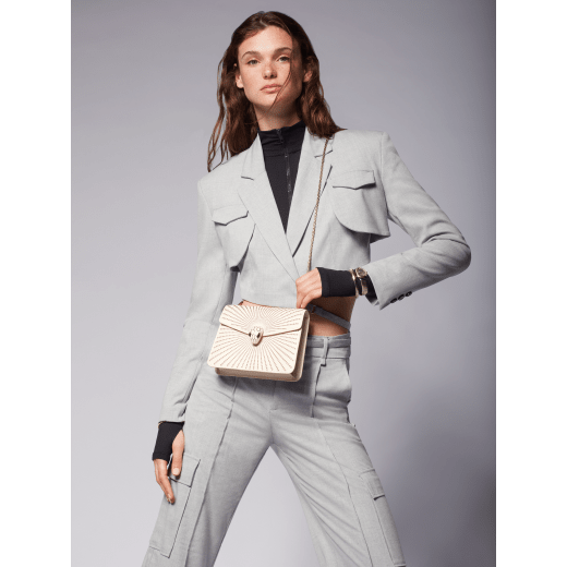 Serpenti Forever crossbody bag in ivory opal laser-cut calf leather with caramel topaz beige nappa leather lining. Captivating snakehead closure in light gold-plated brass embellished with matt and shiny ivory opal enamel scales and black onyx eyes. 422-LCL image 7