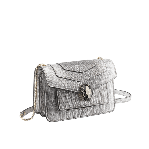 “Serpenti Forever” crossbody bag in charcoal diamond metallic karung skin. Iconic snakehead closure in light gold plated brass enriched with black and glitter hawk's eye enamel and black onyx eyes. 1082-MK image 2