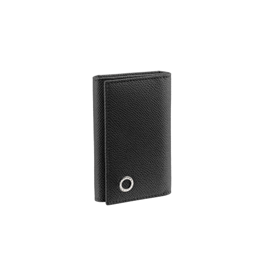 Small keyholder in black grain calf leather with brass palladium plated hardware featuring the Bvlgari-Bvlgari motif. Six internal key holders, two pockets and one open compartment inside. Flap closure with press button. BBM-KEYHOLDER-S image 1