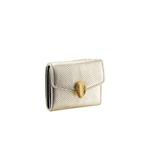 Slender, compact "Serpenti Forever" wallet in "Molten" gold karung skin and black calfskin, offering a touch of radiance for the Winter Holidays. New Serpenti head closure in gold-plated brass, complete with ruby-red enamel eyes. SEA-SLIMCOMPACT-MoltK image 1