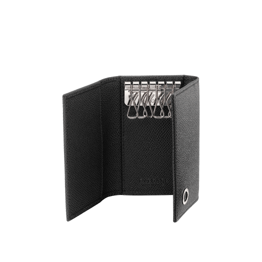 Small keyholder in black grain calf leather with brass palladium plated hardware featuring the Bvlgari-Bvlgari motif. Six internal key holders, two pockets and one open compartment inside. Flap closure with press button. BBM-KEYHOLDER-S image 2