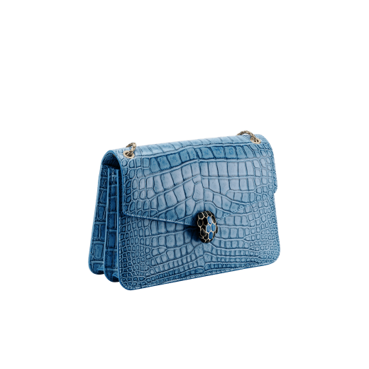 Serpenti Forever shoulder bag in Niagara sapphire blue Cloudy alligator skin with black nappa leather lining. Captivating snakehead closure in light gold-plated brass embellished with black enamel scales, blue jade scales in the centre and black onyx eyes. 291478 image 2