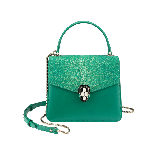 “Serpenti Forever ” crossbody bag in carmine jasper galuchat skin and calf leather. Iconic snakehead closure in light gold plated brass enriched with black and white enamel and green malachite eyes 752-Ga image 1
