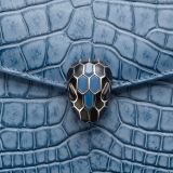 Serpenti Forever shoulder bag in Niagara sapphire blue Cloudy alligator skin with black nappa leather lining. Captivating snakehead closure in light gold-plated brass embellished with black enamel scales, blue jade scales in the centre and black onyx eyes. 291478 image 6