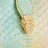 Serpenti Ellipse small crossbody bag in multicolour Spring Shade python skin with sunbeam citrine yellow nappa leather lining. Captivating snakehead closure in gold-plated brass embellished with white mother-of-pearl scales and red enamel eyes. 291736 image 6