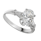 Griffe solitaire ring in platinum with oval shape diamond and two side diamonds. Available from 1 ct. A classic setting that allows the pureness and the beauty of the diamond to assert itself. 331858 image 1