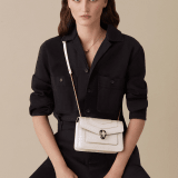 “Serpenti Forever” crossbody bag in white agate calf leather with a varnished and pearled effect. Iconic snakehead closure in light gold plated brass enriched with black and pearled white agate enamel and black onyx eyes. 1082-VCL image 4