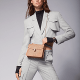 Serpenti Forever crossbody bag in ivory opal laser-cut calf leather with caramel topaz beige nappa leather lining. Captivating snakehead closure in light gold-plated brass embellished with matt and shiny ivory opal enamel scales and black onyx eyes. 422-LCL image 6