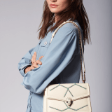 Serpenti Diamond Blast small shoulder bag in ivory opal calf leather with twisted chain and leather décor, and Niagara sapphire blue nappa leather lining. Captivating snakehead closure in light gold-plated brass embellished with matt and shiny ivory opal enamel scales and black onyx eyes. 291725 image 8