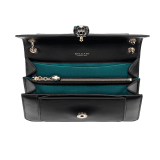 Serpenti Forever medium shoulder bag in black calf leather with emerald green grosgrain lining. Captivating snakehead closure in light gold-plated brass embellished with black and white agate enamel scales and green malachite eyes. 1077-CLa image 4