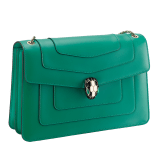 Serpenti Forever medium shoulder bag in black calf leather with emerald green grosgrain lining. Captivating snakehead closure in light gold-plated brass embellished with black and white agate enamel scales and green malachite eyes. 1089-Cla image 2