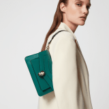 Serpenti Forever East-West small shoulder bag in black calf leather with emerald green gros grain lining. Captivating snakehead magnetic closure in light gold-plated brass embellished with black and white agate enamel scales, and green malachite eyes. 1237-CL image 6