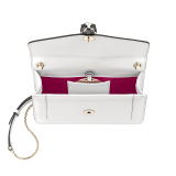 “Serpenti Forever” crossbody bag in agate-white calfskin with Heather Amethyst purple grosgrain inner lining. Iconic snakehead closure in light gold-plated brass embellished with black and agate-white enamel and green malachite eyes 625-CLa image 4