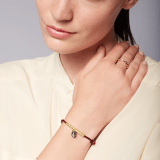 "Serpenti Forever" bracelet in ruby red fabric with a gold-plated brass plate. Iconic snakehead charm enamelled in black and white agate, with seductive black enamel eyes. SERP-MINISTRINGc image 2
