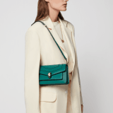 Serpenti Forever East-West small shoulder bag in black calf leather with emerald green gros grain lining. Captivating snakehead magnetic closure in light gold-plated brass embellished with black and white agate enamel scales, and green malachite eyes. 1237-CL image 7