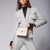 Serpenti Forever crossbody bag in ivory opal laser-cut calf leather with caramel topaz beige nappa leather lining. Captivating snakehead closure in light gold-plated brass embellished with matt and shiny ivory opal enamel scales and black onyx eyes. 422-LCL image 7