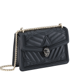 “Serpenti Diamond Blast” shoulder bag in black quilted nappa leather body, featuring a maxi matelassé pattern, and black calf leather frames, with black nappa leather internal lining. Tempting snakehead closure in light gold plated brass enriched with black enamel and black onyx eyes. 922-MFQD image 2