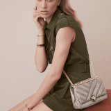 Serpenti Cabochon small shoulder bag in milky opal beige matelassé metallic karung skin with milky opal beige nappa leather lining. Captivating snakehead closure in light gold-plated brass embellished with matt black and glitter milky opal beige enamel scales and black onyx eyes. 1094-MK image 5