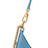 Serpenti Ellipse medium shoulder bag in Urban grain and smooth Niagara sapphire blue calf leather with cloud topaz blue gros grain lining. Captivating snakehead closure in gold-plated brass embellished with black onyx scales and red enamel eyes. 1190-UCL image 5