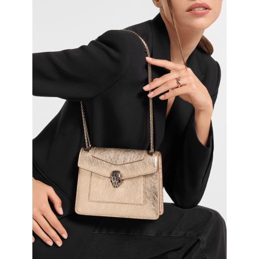 Serpenti Forever Day-to-Night small shoulder bag in silver Striated calf leather with grey nappa leather lining. Captivating snakehead magnetic closure in light gold-plated brass embellished with grey enamel, light gold-plated brass scales and black onyx eyes. SEA-1281-STR image 1