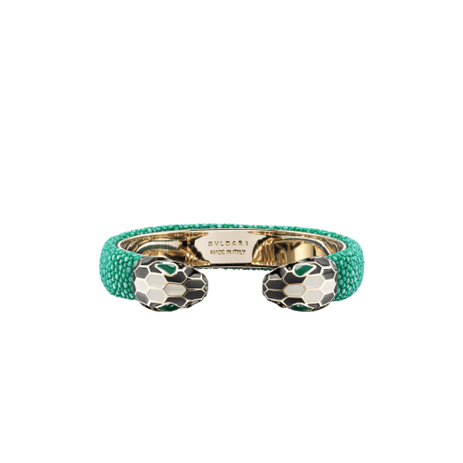 Serpenti Forever bangle bracelet in light gold-plated brass with emerald green galuchat skin inserts. Captivating contraire snakehead motif embellished with black and white agate enamel scales and emerald green enamel eyes. SPContr-G-EG image 1