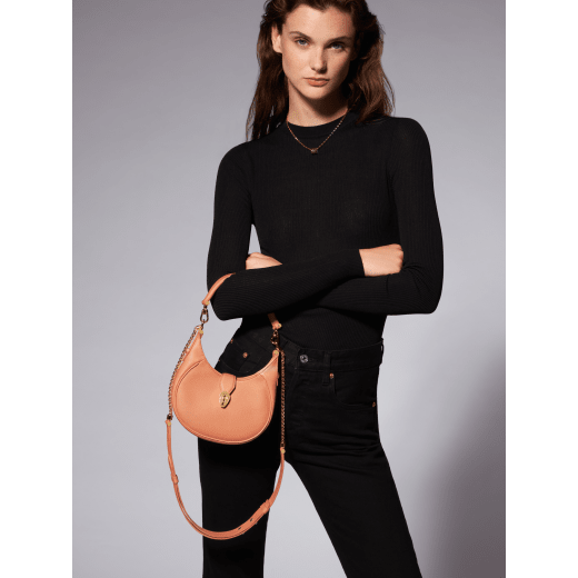 Serpenti Ellipse small crossbody bag in coral carnelian orange Urban grained calf leather with silky coral pink grosgrain lining. Captivating snakehead closure in gold-plated brass embellished with black onyx scales and red enamel eyes. 1204-UCLb image 7