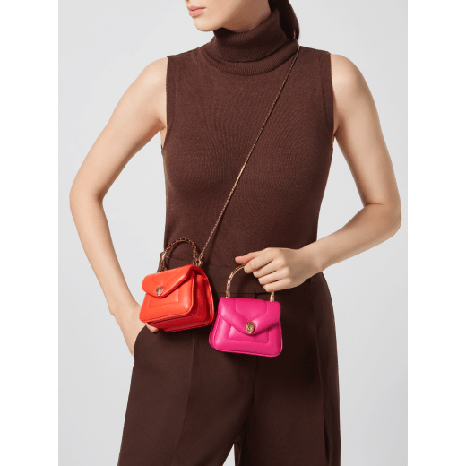 Serpenti Reverse micro top handle bag in truly tourmaline fuchsia Metropolitan calf leather with royal ruby red nappa leather lining. Captivating snakehead magnetic closure in gold-plated brass embellished with red enamel eyes. SRV-NANOREVERSE-MCL image 2