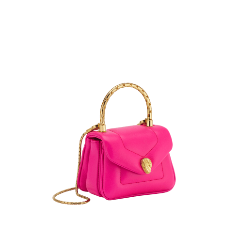 Serpenti Reverse micro top handle bag in truly tourmaline fuchsia Metropolitan calf leather with royal ruby red nappa leather lining. Captivating snakehead magnetic closure in gold-plated brass embellished with red enamel eyes. SRV-NANOREVERSE-MCL image 1
