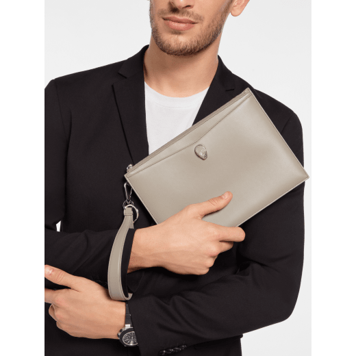 Serpenti Forever pouch in black calf leather with black nappa leather interior. Captivating snakehead rivet in dark ruthenium-plated brass embellished with red enamel eyes. SEA-UNIPOUCH-CL image 2