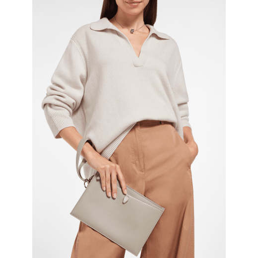 Serpenti Forever pouch in black calf leather with black nappa leather interior. Captivating snakehead rivet in dark ruthenium-plated brass embellished with red enamel eyes. SEA-UNIPOUCH-CL image 1