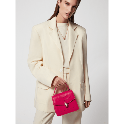 “Serpenti Forever ” top-handle bag in Lavender Amethyst lilac calf leather with Reef Coral red grosgrain inner lining. Iconic snakehead closure in light gold-plated brass embellished with black and white agate enamel and green malachite eyes. 1122-CLb image 6