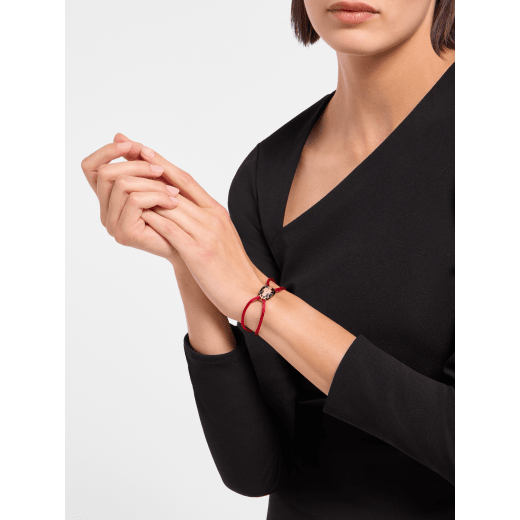 "Serpenti Forever" bracelet in Midnight Sapphire blue fabric with an alluring snakehead décor in light gold-plated brass enamelled in black and glittery Hawk's Eye grey, with seductive black enamel eyes. SERP-STRINGd image 2