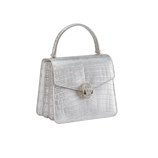 Serpenti Forever small top handle bag in white Snow Crystal crocodile skin with black nappa leather lining. Captivating snakehead press-stud closure in light gold-plated brass embellished with matt silver enamel scales and black onyx eyes. 292926 image 2