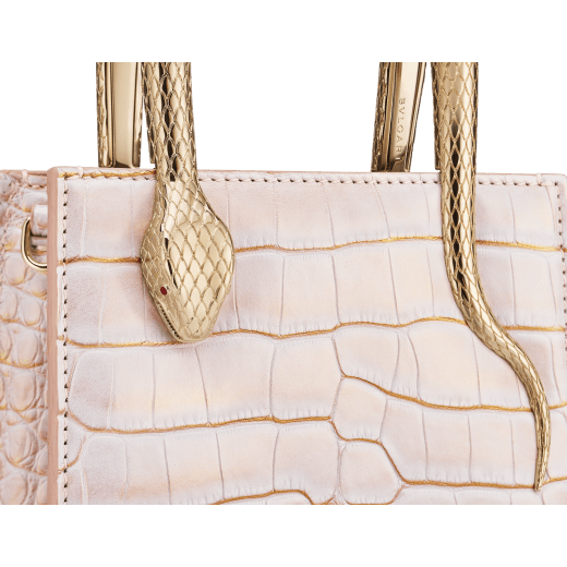 Serpentine mini tote bag in white Moonpearl alligator skin with crystal rose nappa leather lining. Captivating snake body-shaped handles in light gold-plated brass embellished with engraved scales and red enamel eyes. 293444 image 6