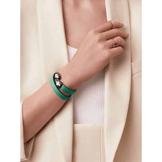 Serpenti Forever two-coil bracelet in emerald green calf leather. Captivating single-rivet contraire snakehead closure in light gold-plated brass embellished with black and white agate enamel scales and green enamel eyes. MCSerp-CL-EG image 3