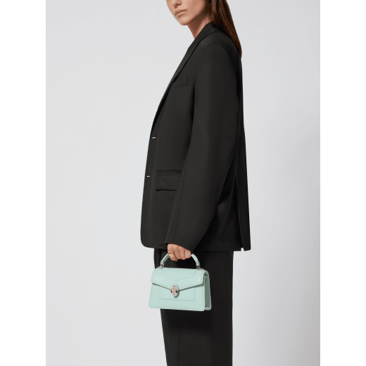 Serpenti Forever mini top handle bag in black calf leather with black nappa leather lining. Captivating snakehead magnetic closure in light gold-plated brass embellished with black enamel and light gold-plated brass scales, and black onyx eyes. SEA-1283-CL image 1