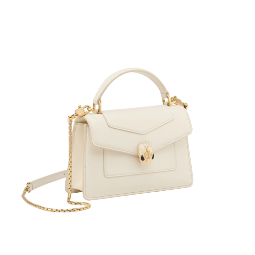 Serpenti Forever mini top handle bag in royal ruby calf leather with royal ruby nappa leather lining. Captivating snakehead magnetic closure in gold-plated brass embellished with royal ruby enamel and gold-plated brass scales, and black onyx eyes. SEA-001-1283XS image 2