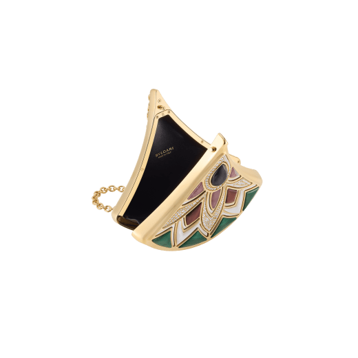 The Bvlgari Icons Minaudière Limited Edition collection reinterprets Bvlgari's timeless symbols, bridging the universes of jewellery and accessories with designs that embody both heritage and innovation. The Divas’ Dream Minaudière features a sculptural fan-shaped silhouette inspired by Rome's Caracalla mosaics, crafted in gold-finished aluminium and palladium-finished brass and adorned with intricate inserts of coloured gemstones and sparkling zirconia pavé. The creation is completed by a chain for hand-carry and features a single compartment with black nappa leather lining and a press-button closure. A refined objet d'art, the minaudière is accompanied by a specially designed miniature book, ‘Notes on Cultivating Inner Calm’ by Kim Ji-won, perfectly designed to fit its shape. Made in Italy. 295242 image 3
